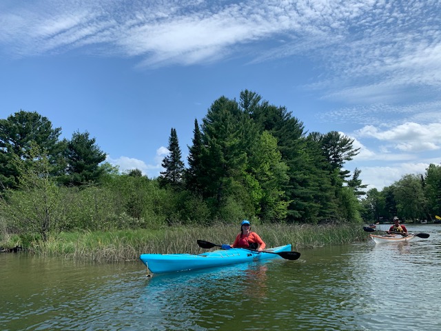 Kayakers on Intermediate River in the upper chain of the Chain of Lakes Water Trail